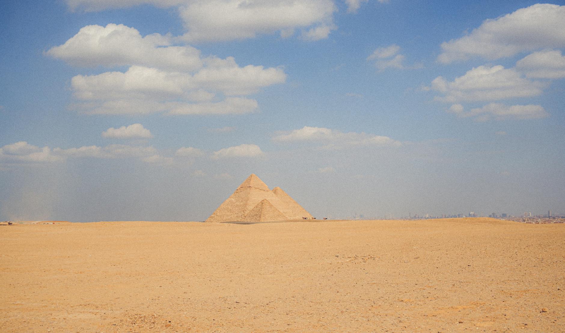 Pyramids of Giza Complete Visitor Guide — History, Tickets, and Tips 2 Panoramic view of the three Pyramids of Giza against a clear blue sky in Egypt