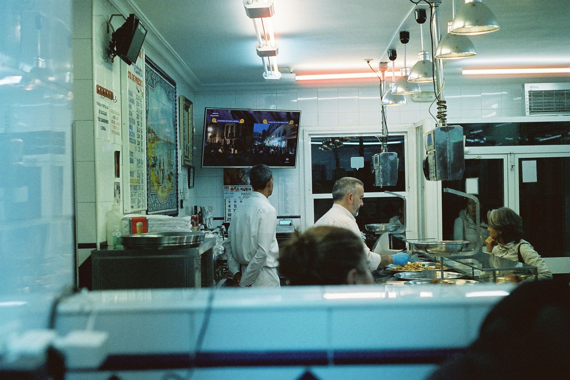 Busy koshary shop counter in downtown Cairo with staff serving Egypt's national dish