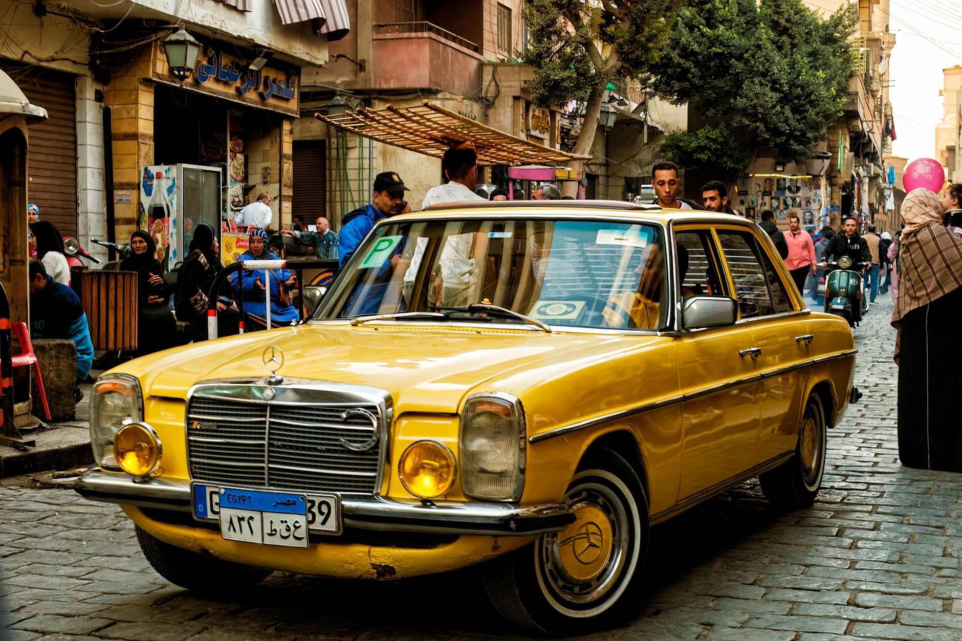 Busy street scene in central Cairo, Egypt, with traffic and pedestrians