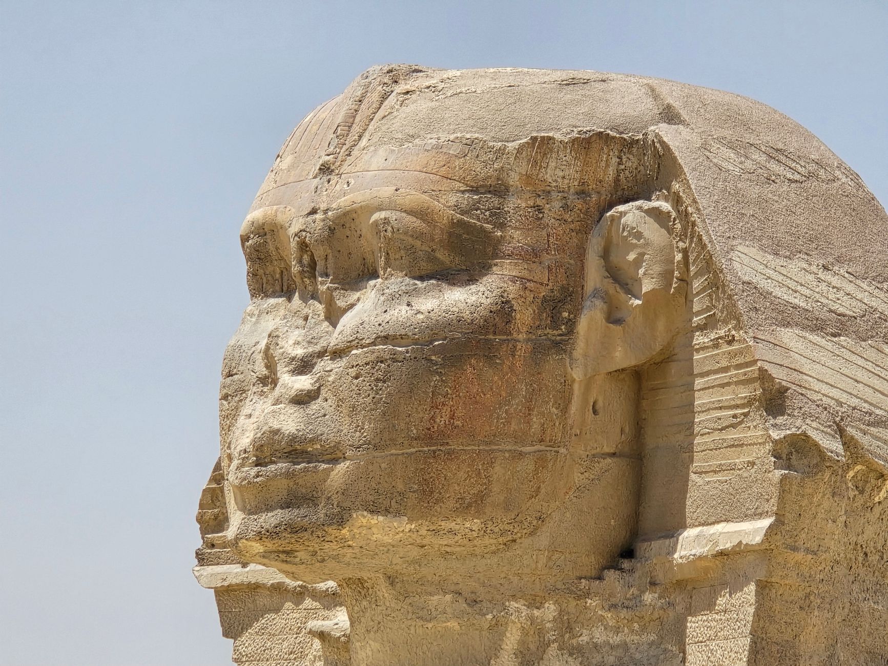 Close-up of the weathered limestone face of the Great Sphinx of Giza in Egypt