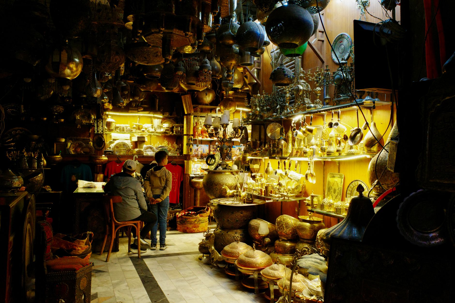 Rainy Day Activities in Cairo: Indoor Fun Ideas 4 Cozy interior of a traditional Cairo cafe with warm lighting and patrons drinking tea, Egypt