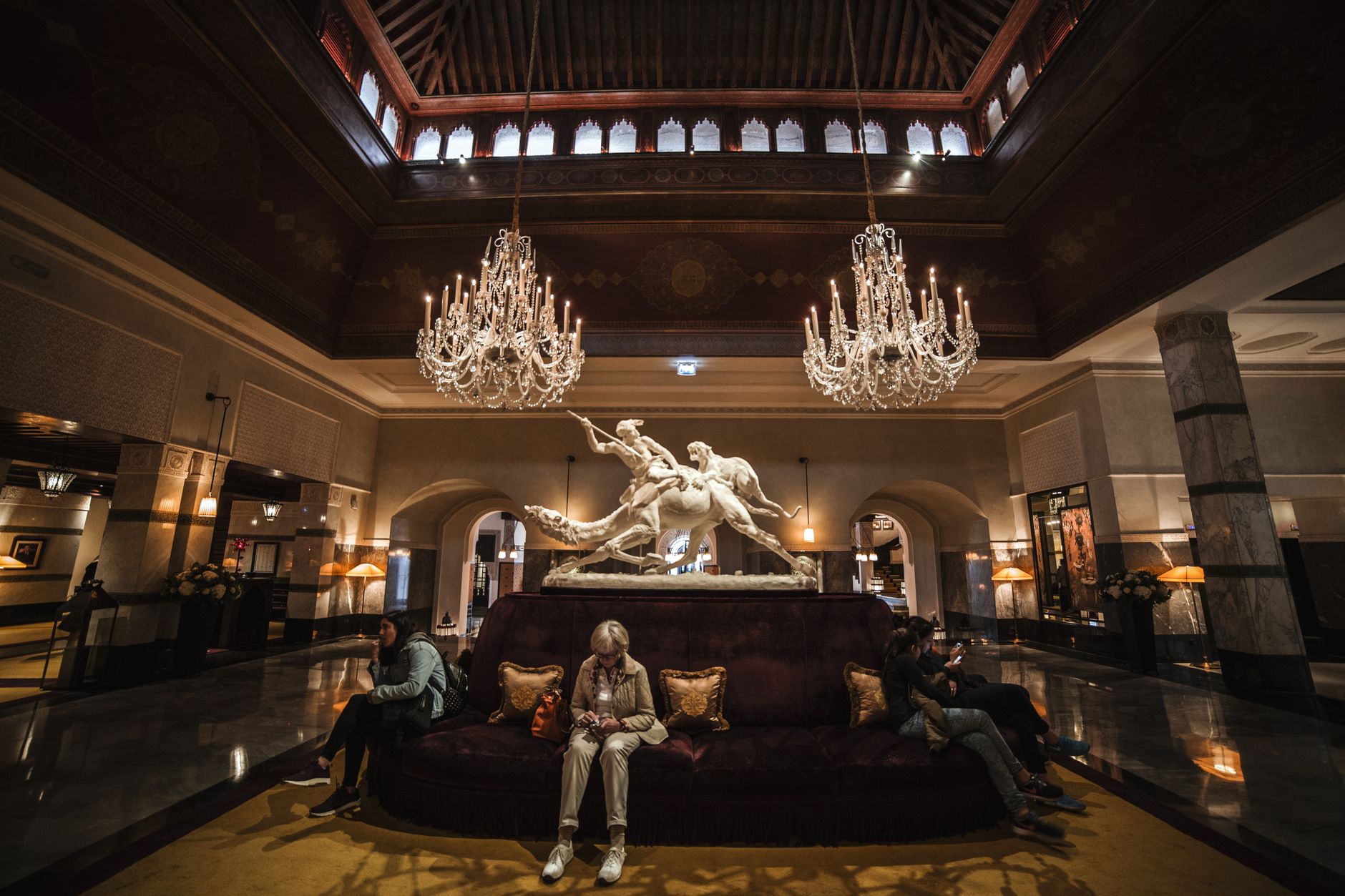 Grand luxury hotel lobby in Cairo with marble floors, chandeliers and ornate detailing