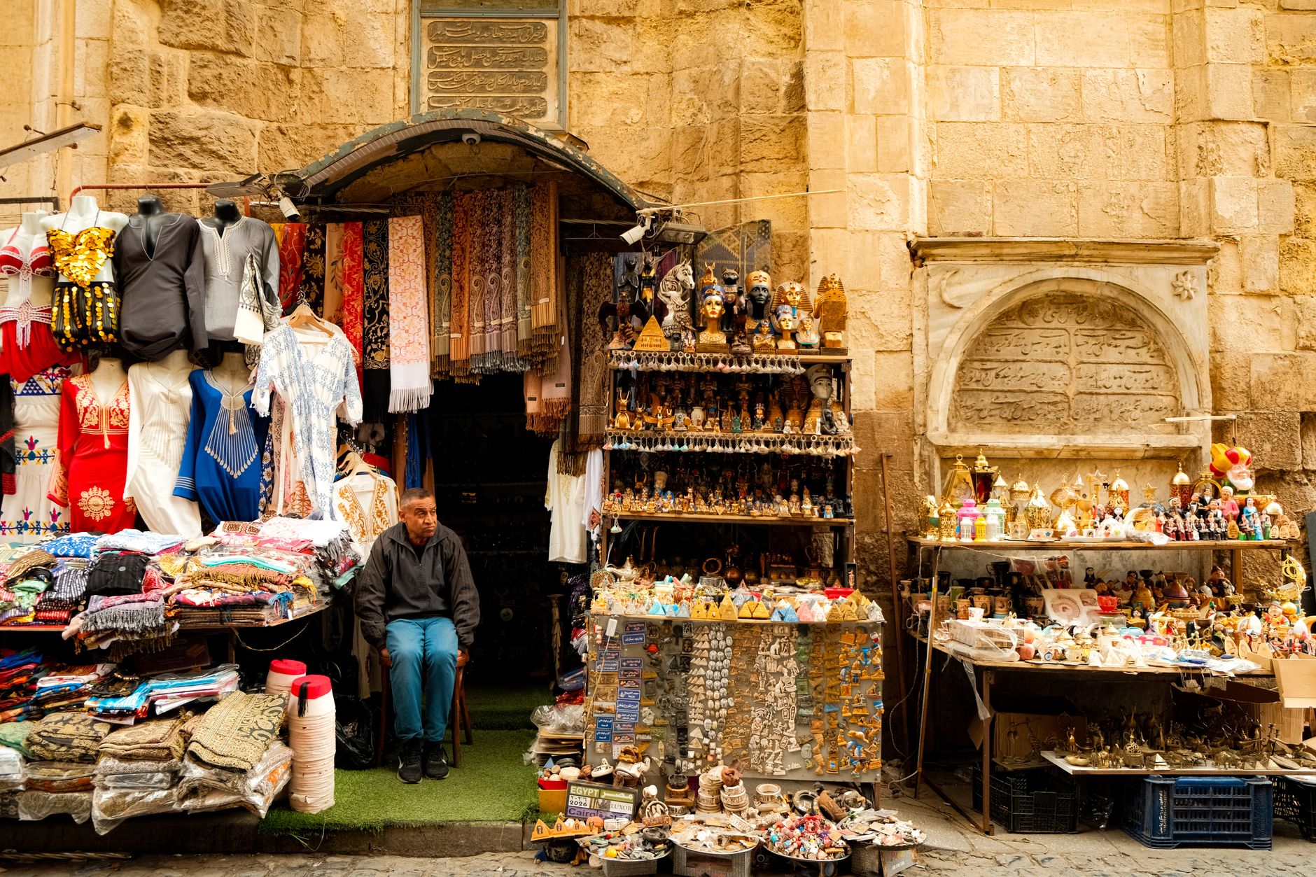 Lantern-lit alley of the Khan el-Khalili bazaar at night with brass lamps and stalls in Cairo, Egypt