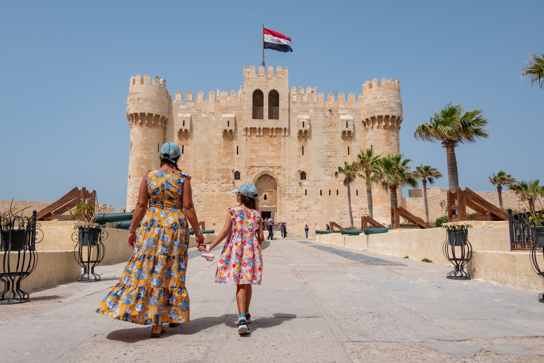 Cairo Culture, Etiquette and Practical Tips for Visitors 3 Modestly dressed travellers with scarves at a historic site in Cairo Egypt