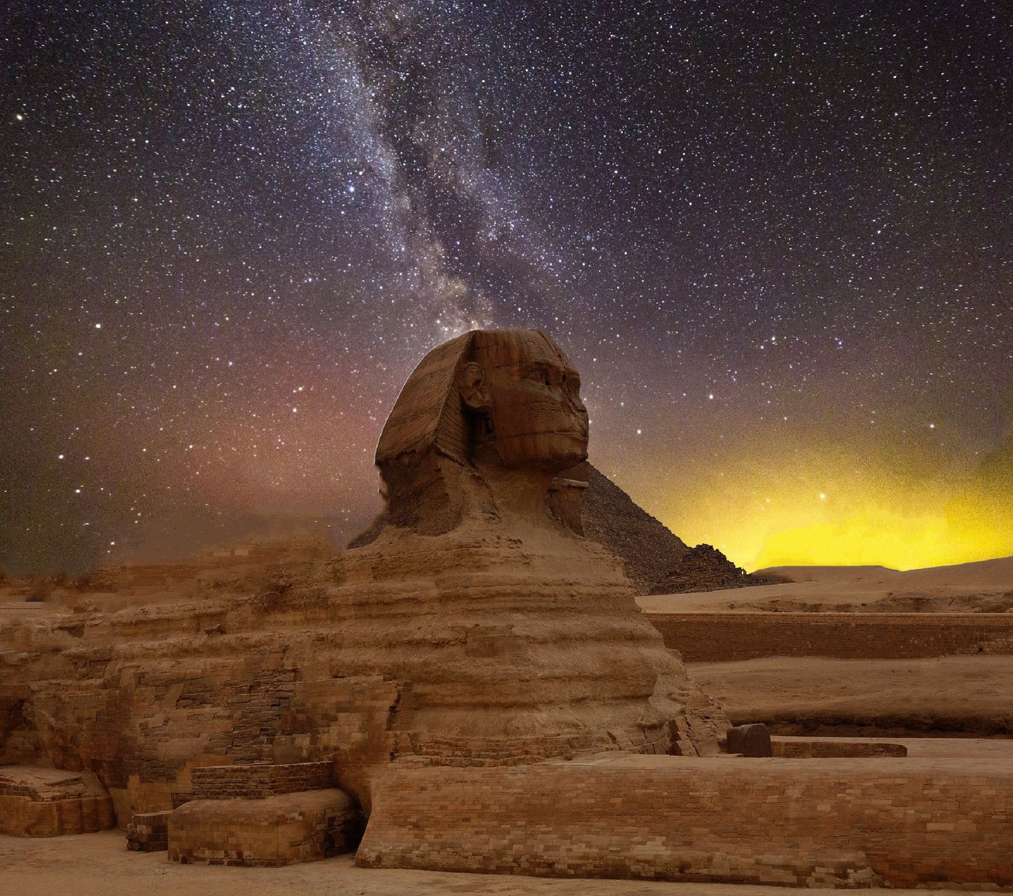 Pyramids of Giza silhouetted against the night sky in Cairo Egypt