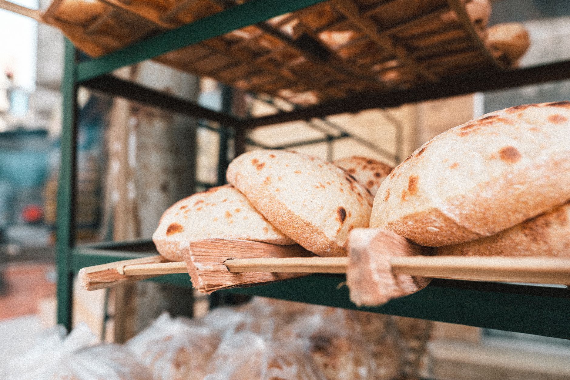 Egyptian Breakfast Guide: Morning Meals in Cairo 4 Stacks of fresh aish baladi whole-wheat flatbread at a traditional Cairo bakery