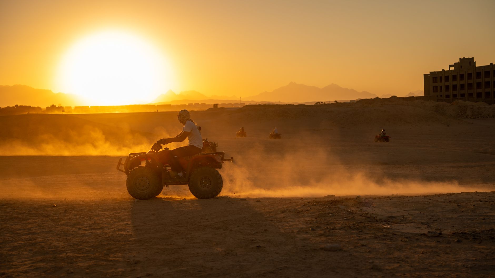 Outdoor Activities in Cairo Egypt: Adventure Options 3 Tourist quad biking an ATV across the desert near the Pyramids, Cairo Egypt