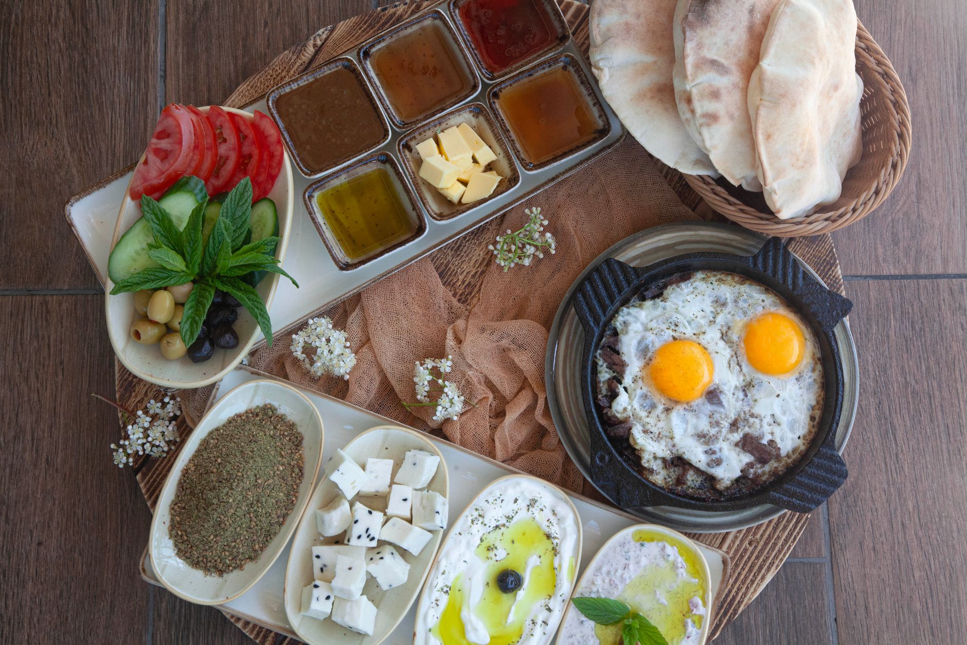 Traditional Egyptian breakfast spread in Cairo with foul medames, white cheese, tomatoes, olives and baladi bread