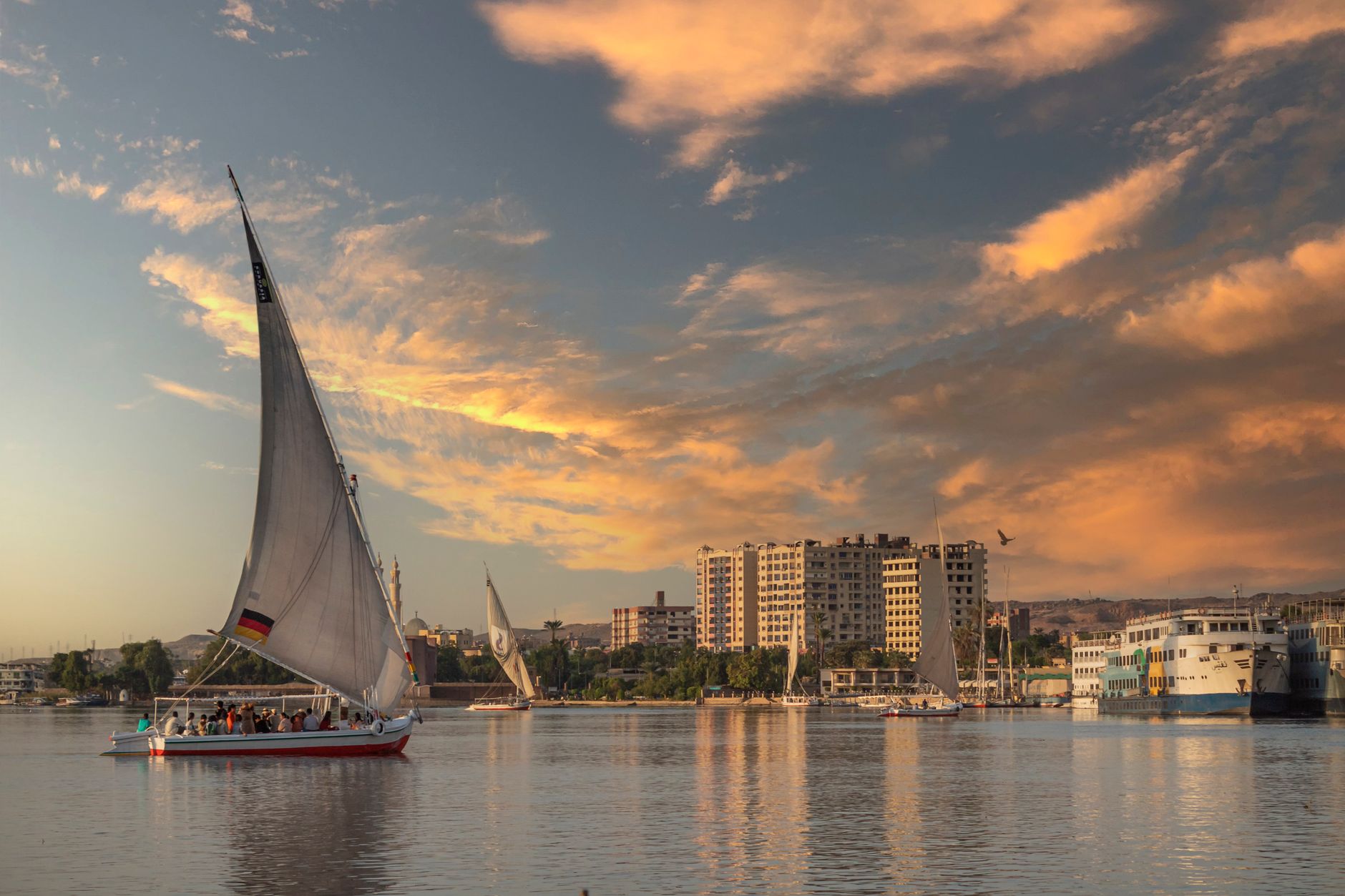 Traditional wooden felucca sailboat on the Nile River at sunset in Cairo, Egypt