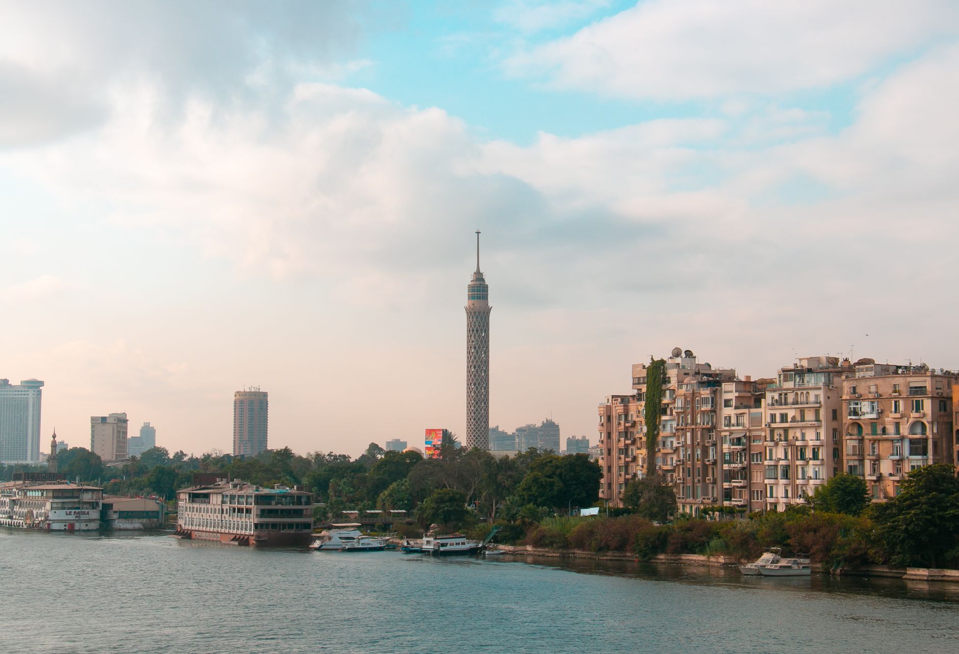 Sunset Nile Cruise Cairo: Perfect Evening Experience 3 Golden hour light on the Nile with Cairo Tower in the distance