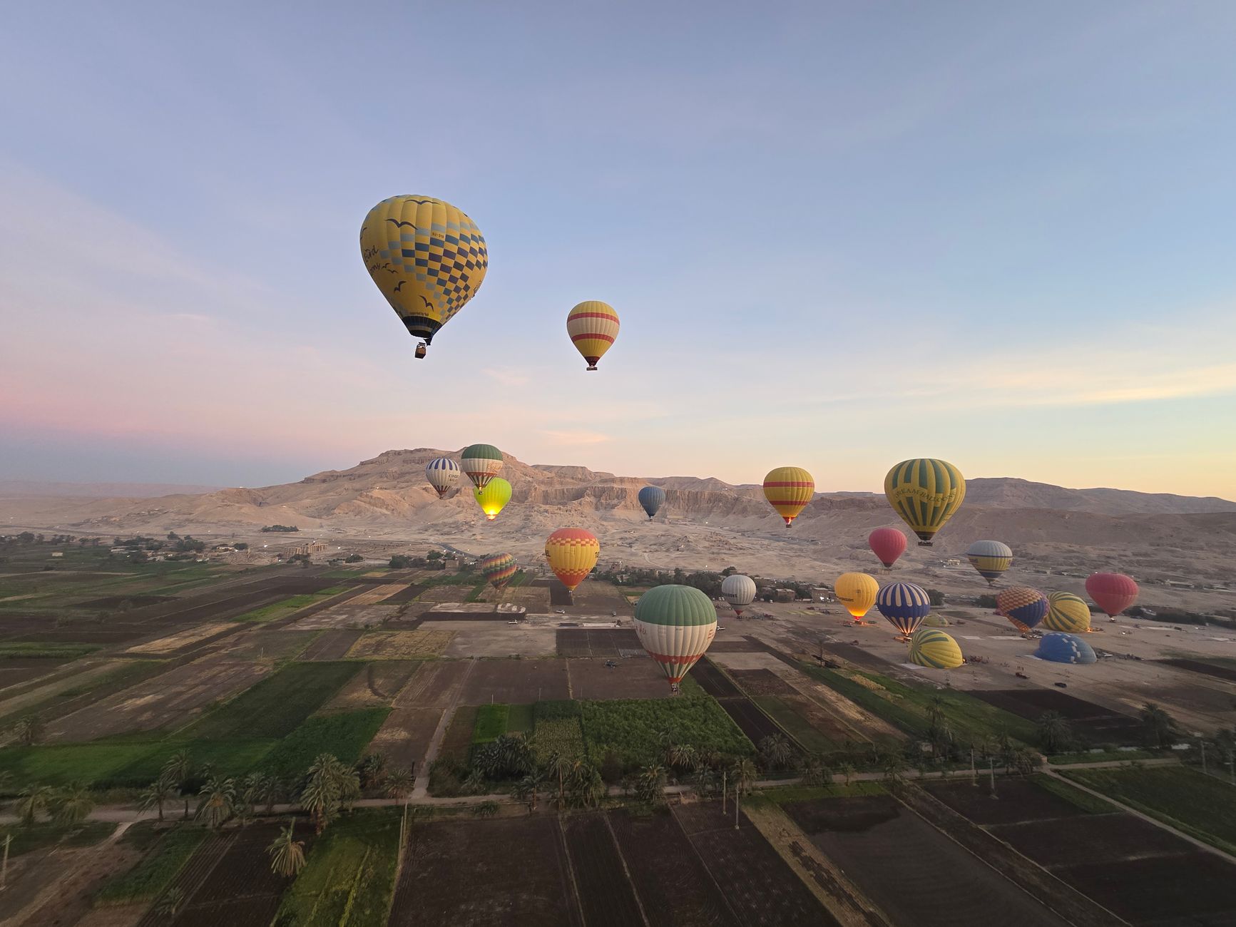 Hot air balloons over the Nile at sunrise near Luxor