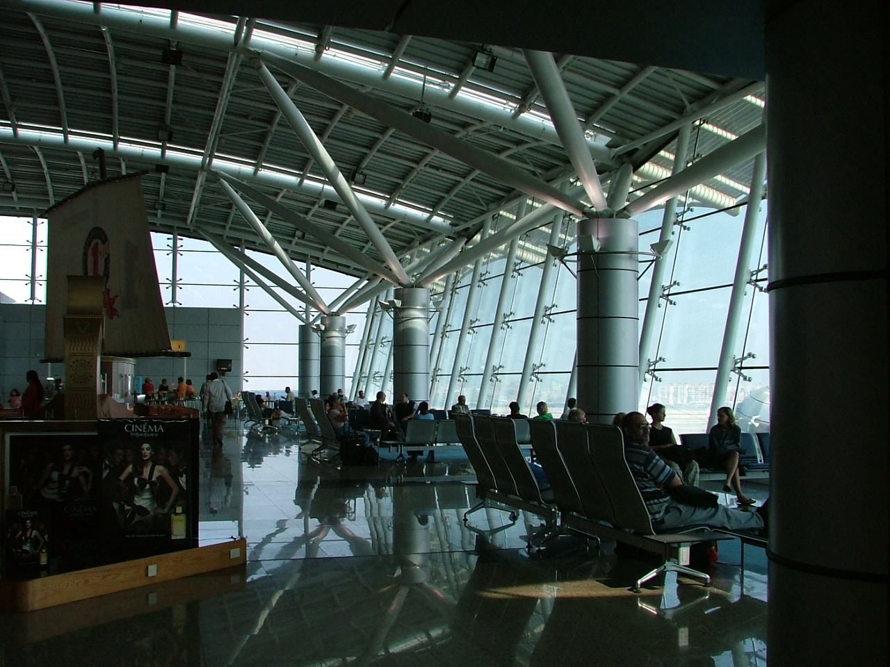 Cairo Airport Lounges: Access, Priority Pass and Reviews 4 Rows of seats in a glass-walled departure lounge in Terminal 1 at Cairo International Airport