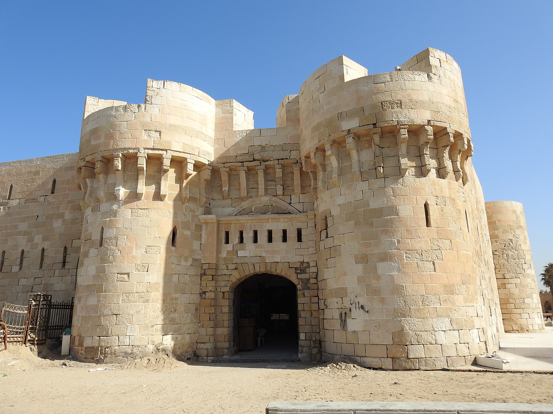 Cairo and Alexandria Itinerary: Five Days, Two Cities 3 The main gate of the Citadel of Qaitbay in Alexandria, flanked by two round stone towers under a blue sky