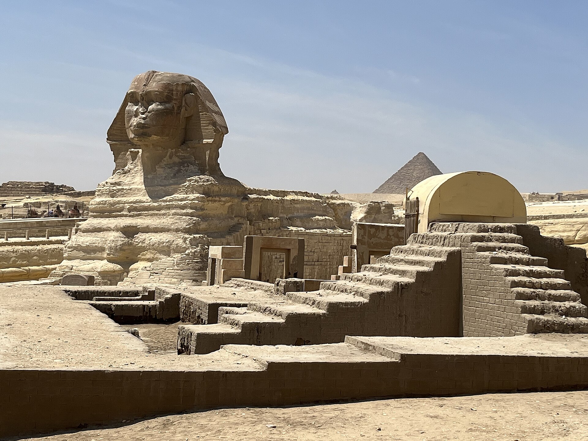 Best Cairo Layover Tours: Seeing the Pyramids Between Flights 3 The Great Sphinx of Giza with the Pyramid of Menkaure behind it and the excavated remains of the Sphinx temple in the foreground