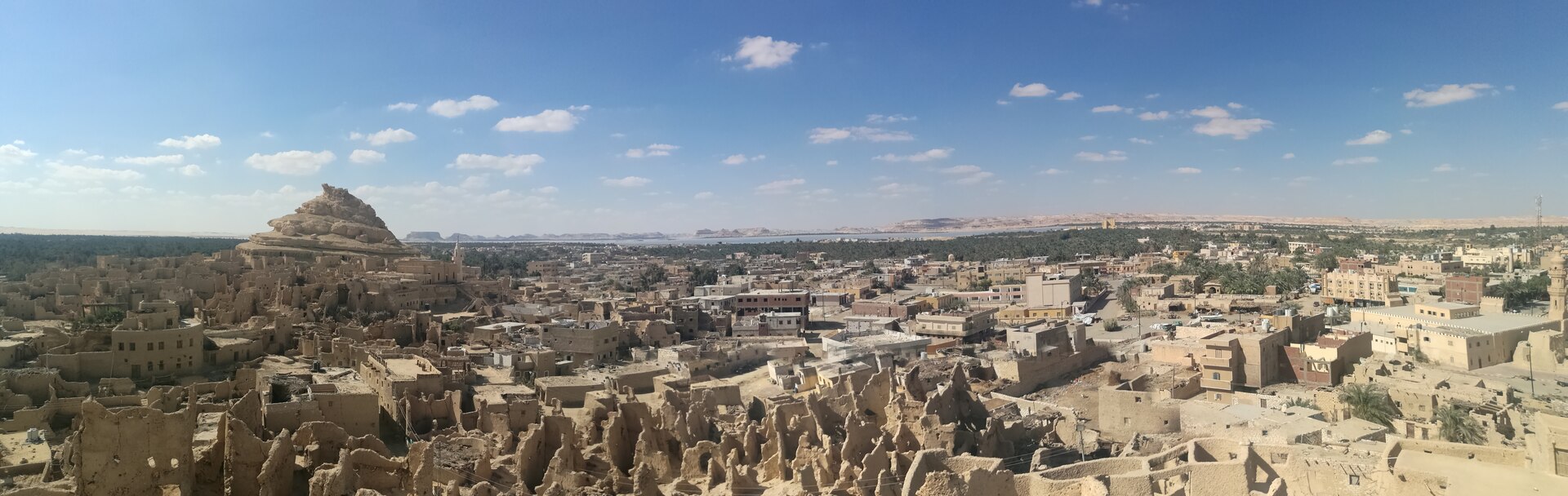Panoramic view over the mud-brick ruins of Shali fortress and the palm groves of Siwa Oasis