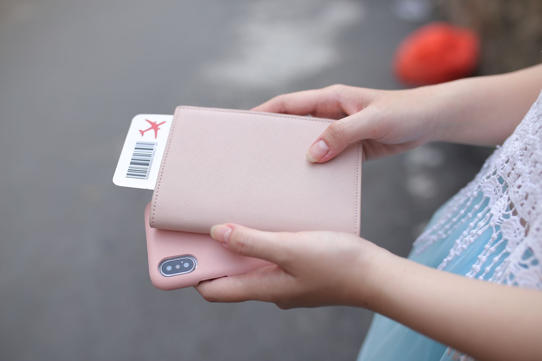 Grand Egyptian Museum Tickets and Prices: How to Book Online 3 A traveller holding a passport wallet with a printed ticket tucked inside alongside a smartphone