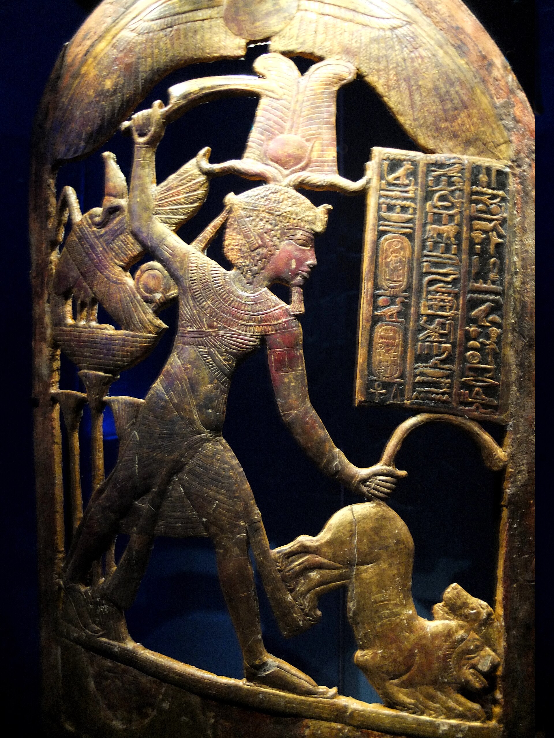 Tutankhamun Galleries at the Grand Egyptian Museum: What You Will See 2 Gilded openwork ceremonial shield from Tutankhamun's tomb showing the king striding over a lion