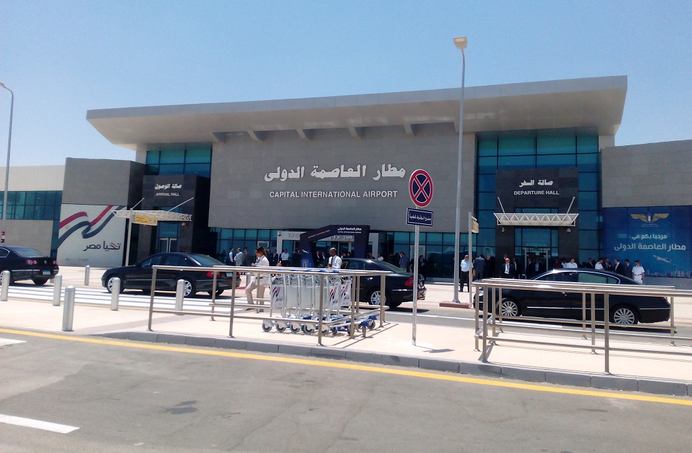 Sphinx International Airport and Cairo's Other Airports 4 The entrance of Capital International Airport, a low modern terminal with its name in Arabic and English above glass doors, cars and luggage trolleys outside